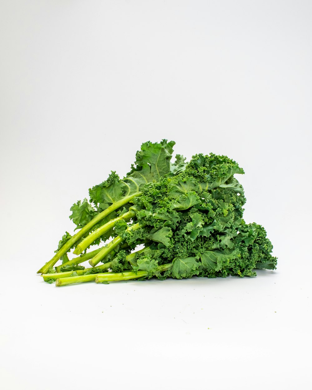 a pile of broccoli sitting on top of a white table