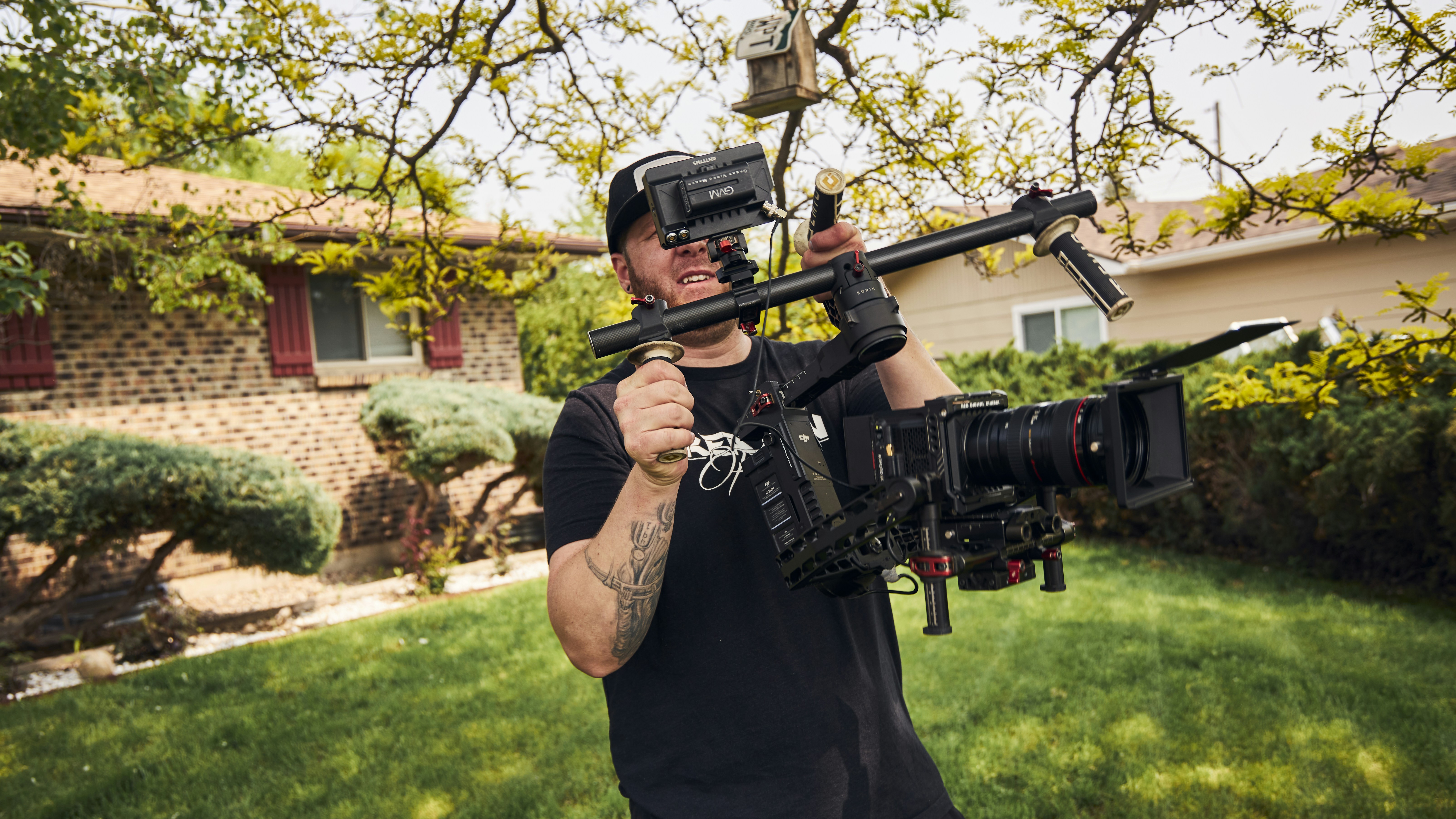 a man holding a camera and a video camera