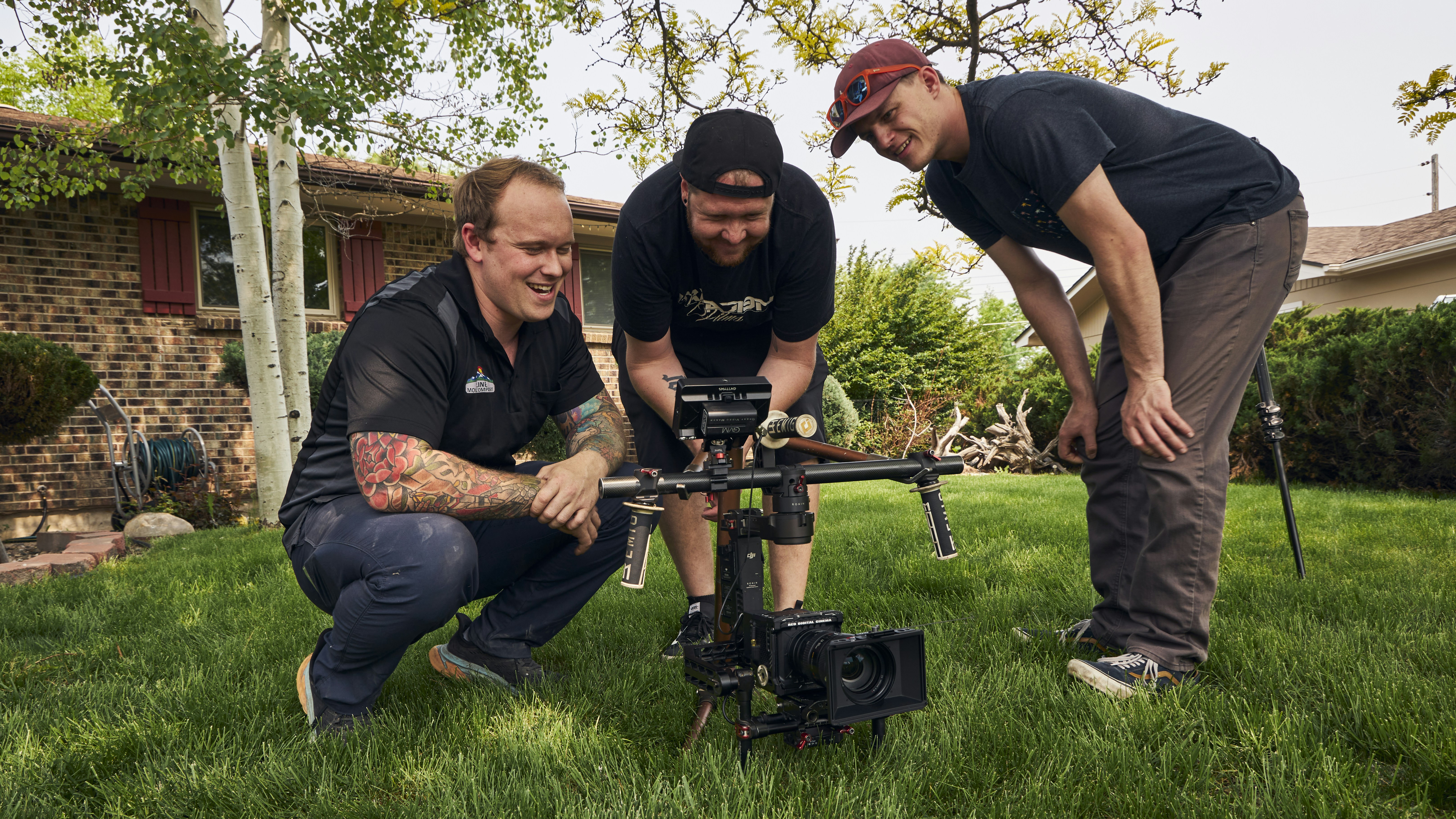 a couple of men standing next to each other on a lush green field
