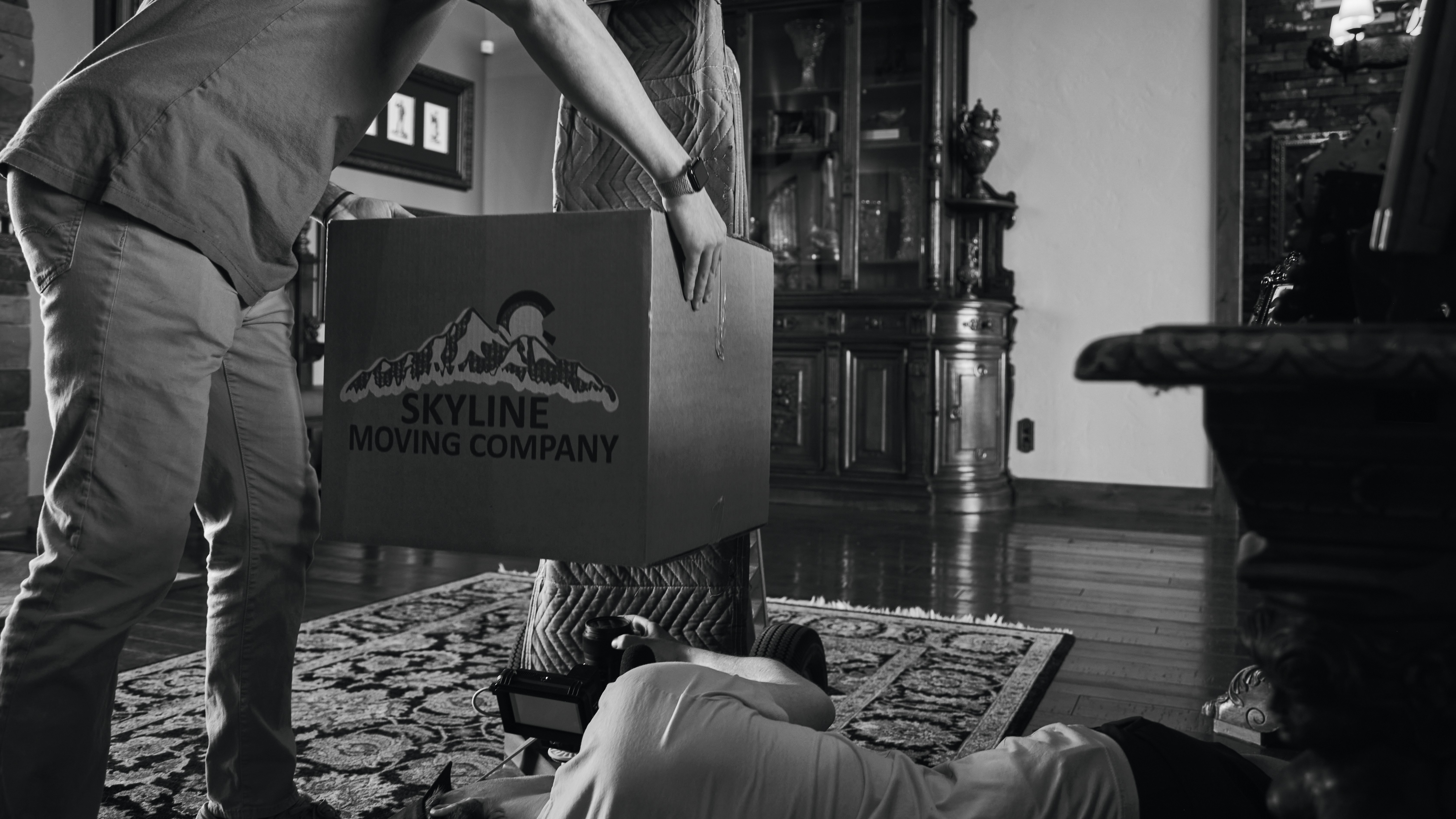 a man opening a moving box on the floor