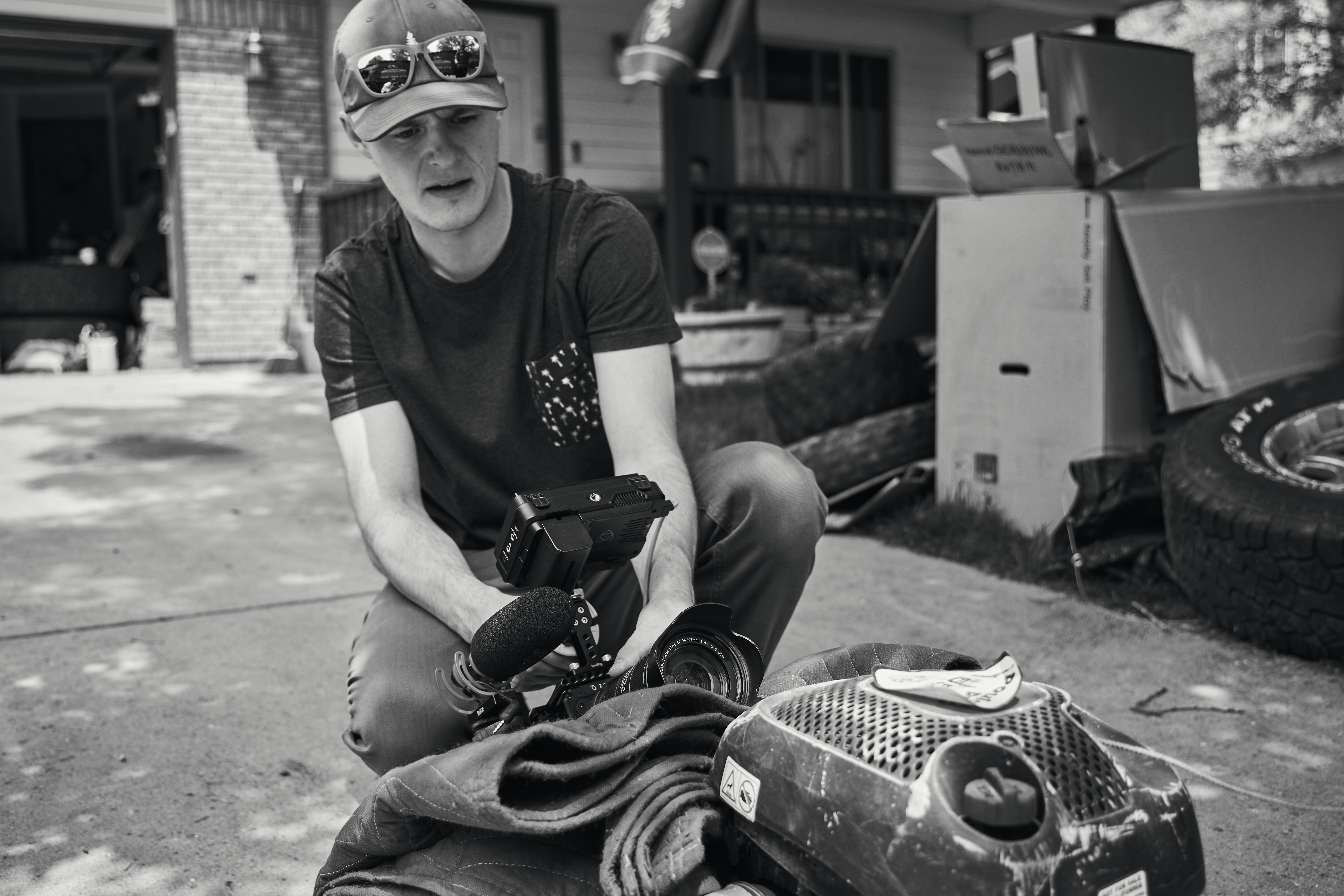 a man kneeling down with a camera in his hand