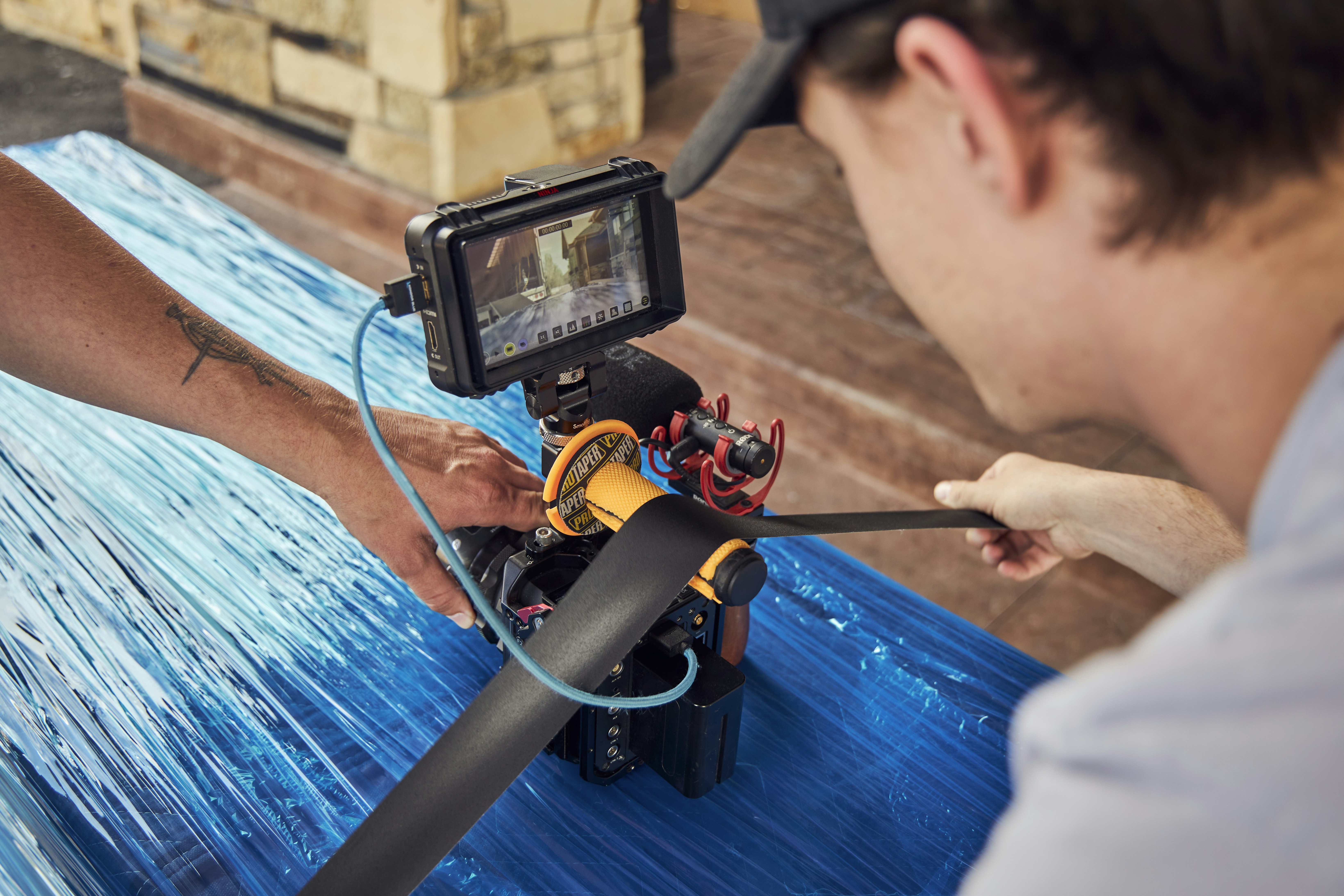 a man with a camera on top of a table