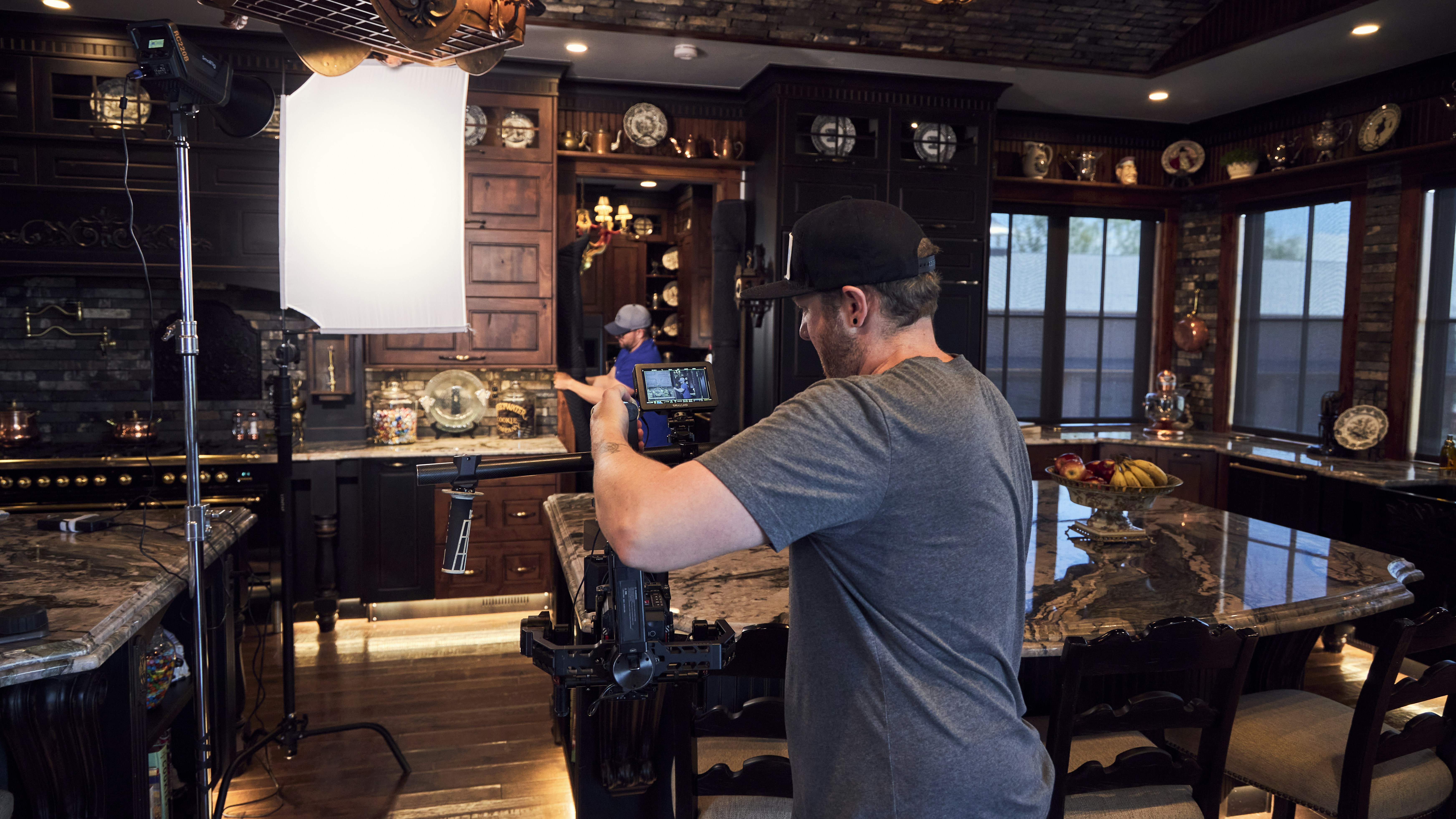 a man standing in a kitchen next to a counter