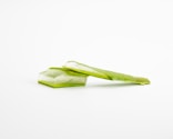 a piece of celery sitting on top of a white surface