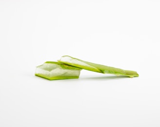 a piece of celery sitting on top of a white surface