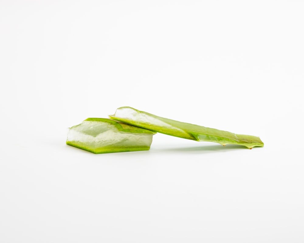 a piece of celery sitting on top of a white surface