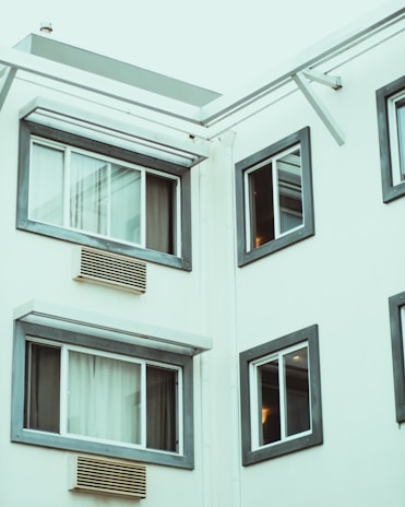 Modern aluminum window installation on a residential building exterior.