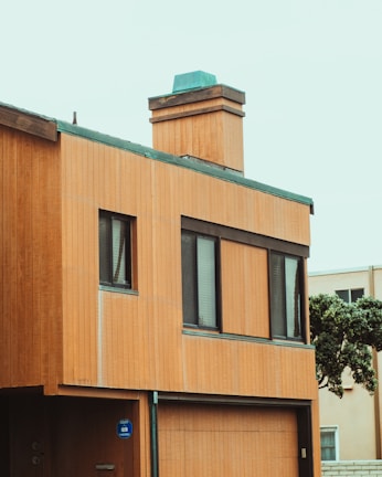 Front view of a modern 20ft accessory dwelling unit with large windows and wood paneling.