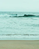 A serene beach scene with waves gently rolling onto the shore.