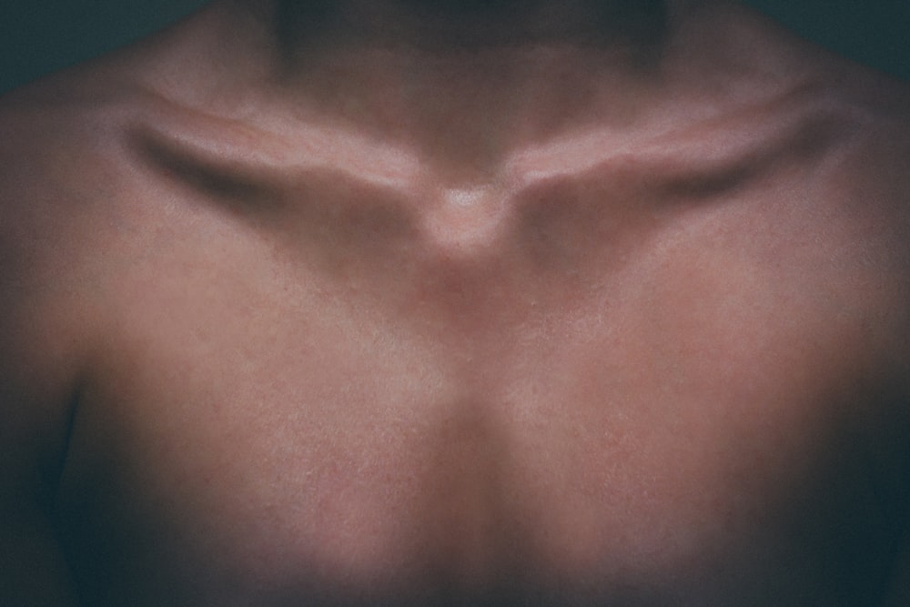 a close up of a man's chest with no shirt on