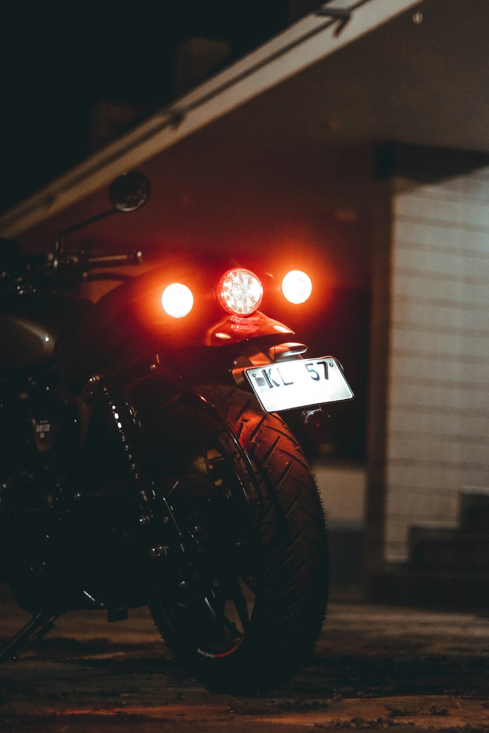a motorcycle parked in front of a building at night