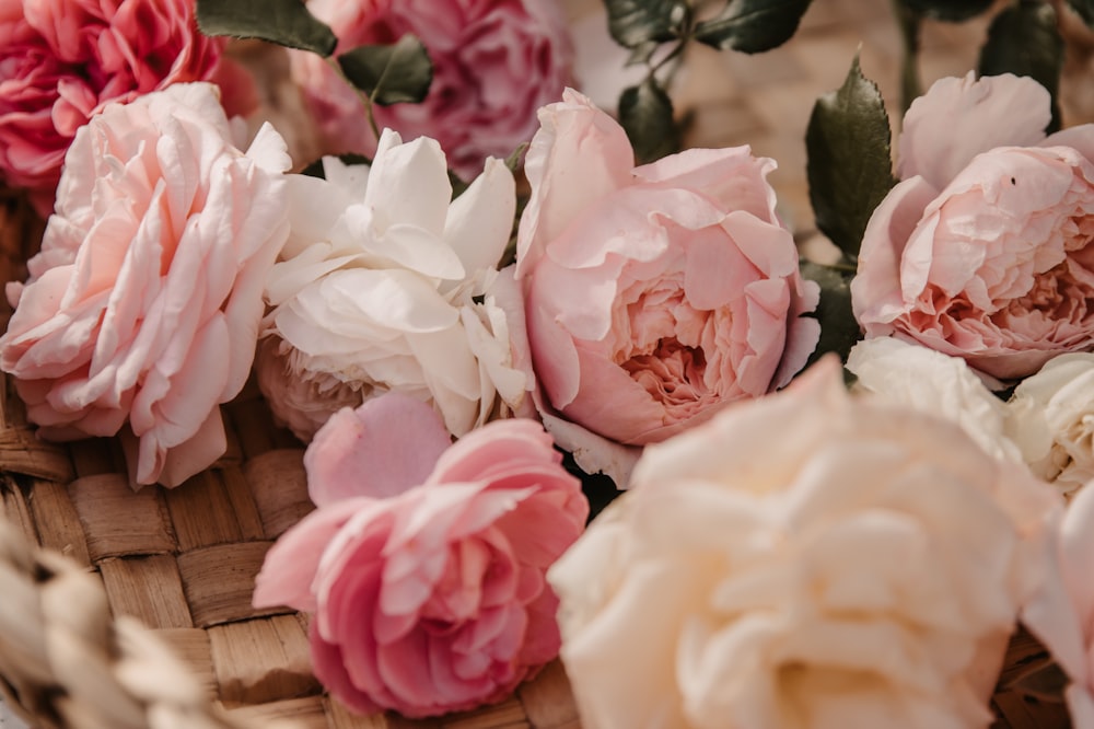 a basket filled with lots of pink and white flowers