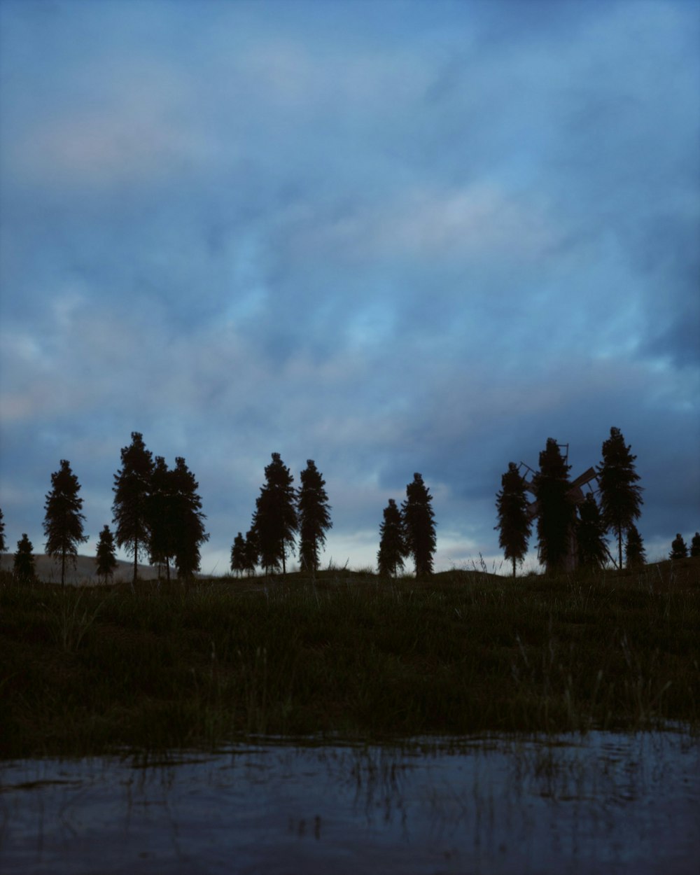 a group of trees sitting on top of a lush green field