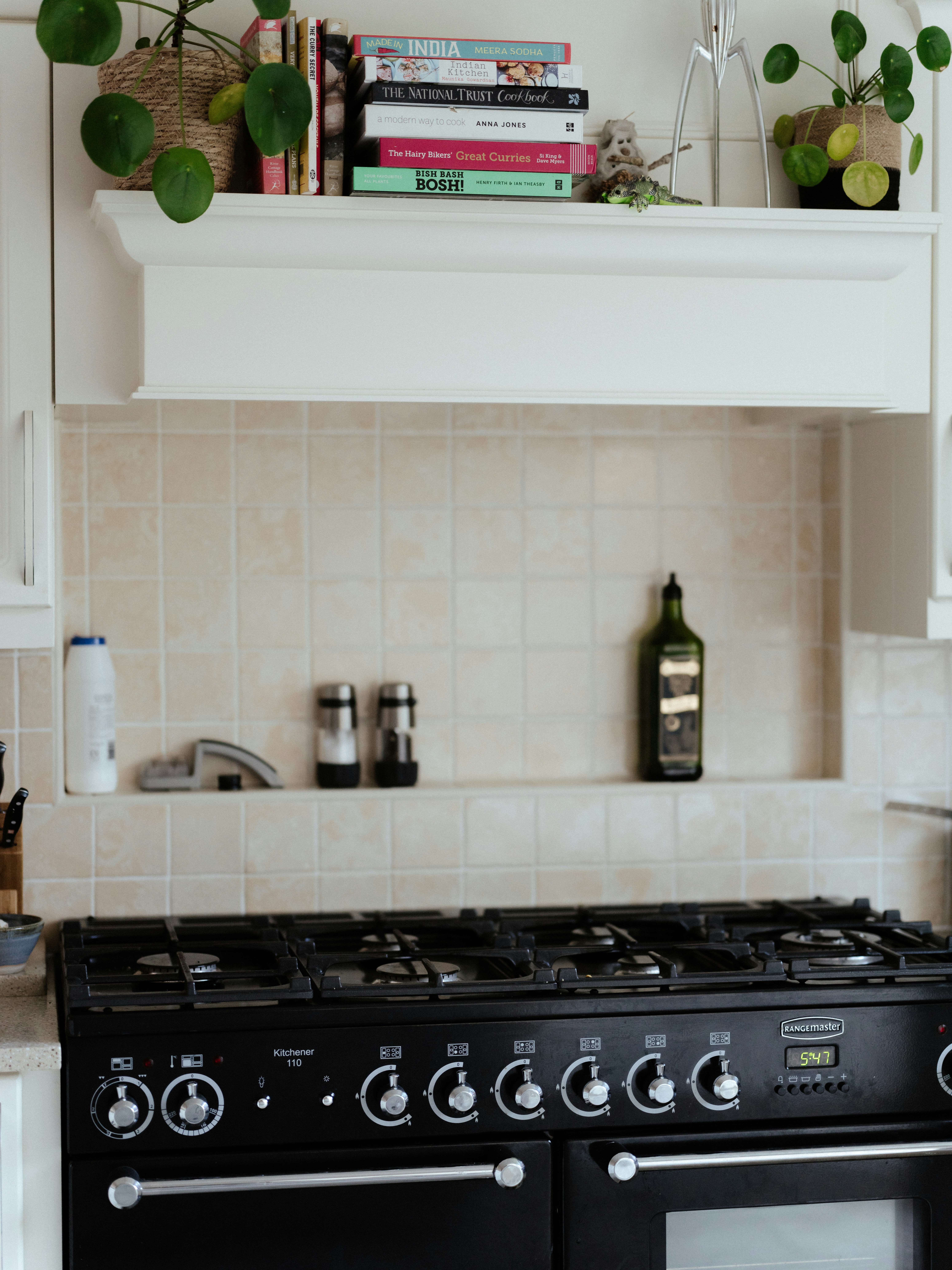 a black stove top oven sitting inside of a kitchen