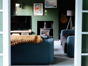 a living room filled with furniture and a flat screen tv
