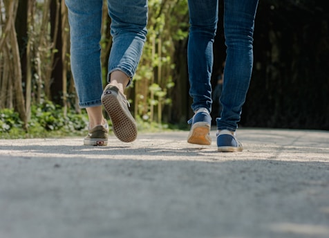 a couple of people walking down a street