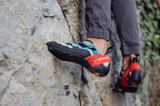 a person climbing up the side of a mountain