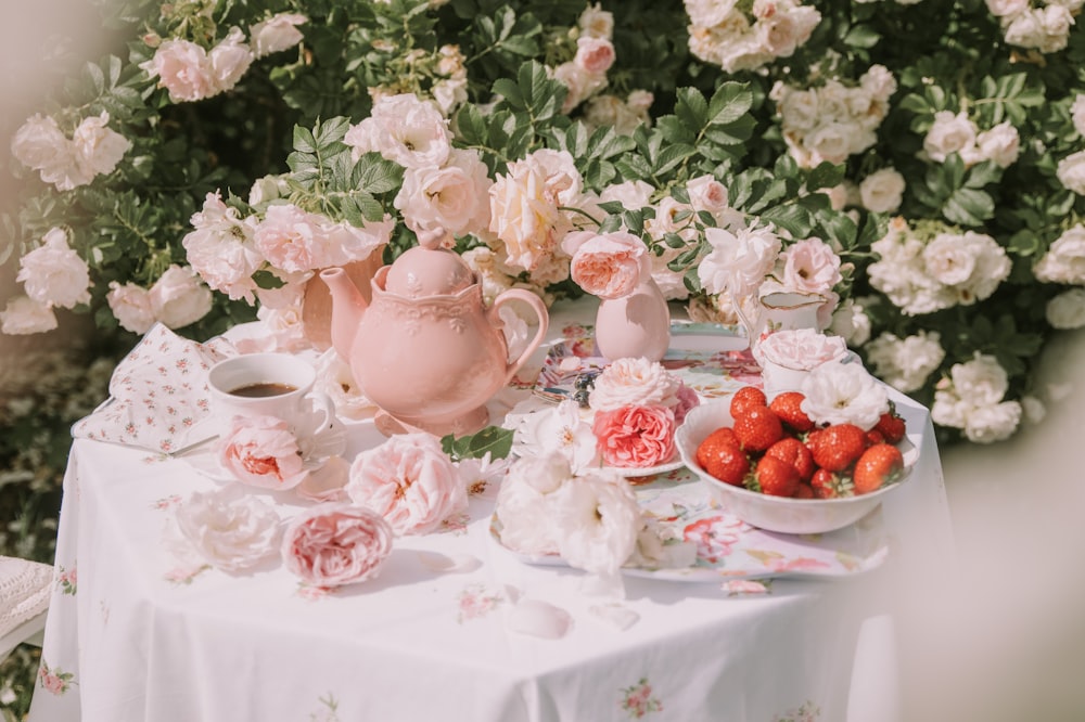 a table topped with plates and bowls of food