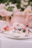 Close-up of a beautifully decorated modern dessert with blue and white accents on a dark blue plate