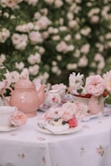a table topped with a plate of food next to a vase of flowers