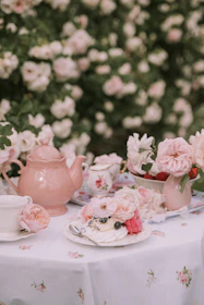 a table topped with a plate of food next to a vase of flowers
