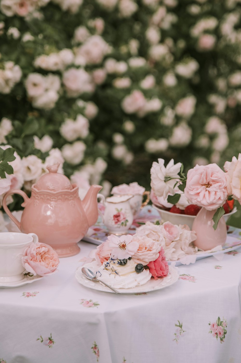 a table topped with a plate of food next to a vase of flowers