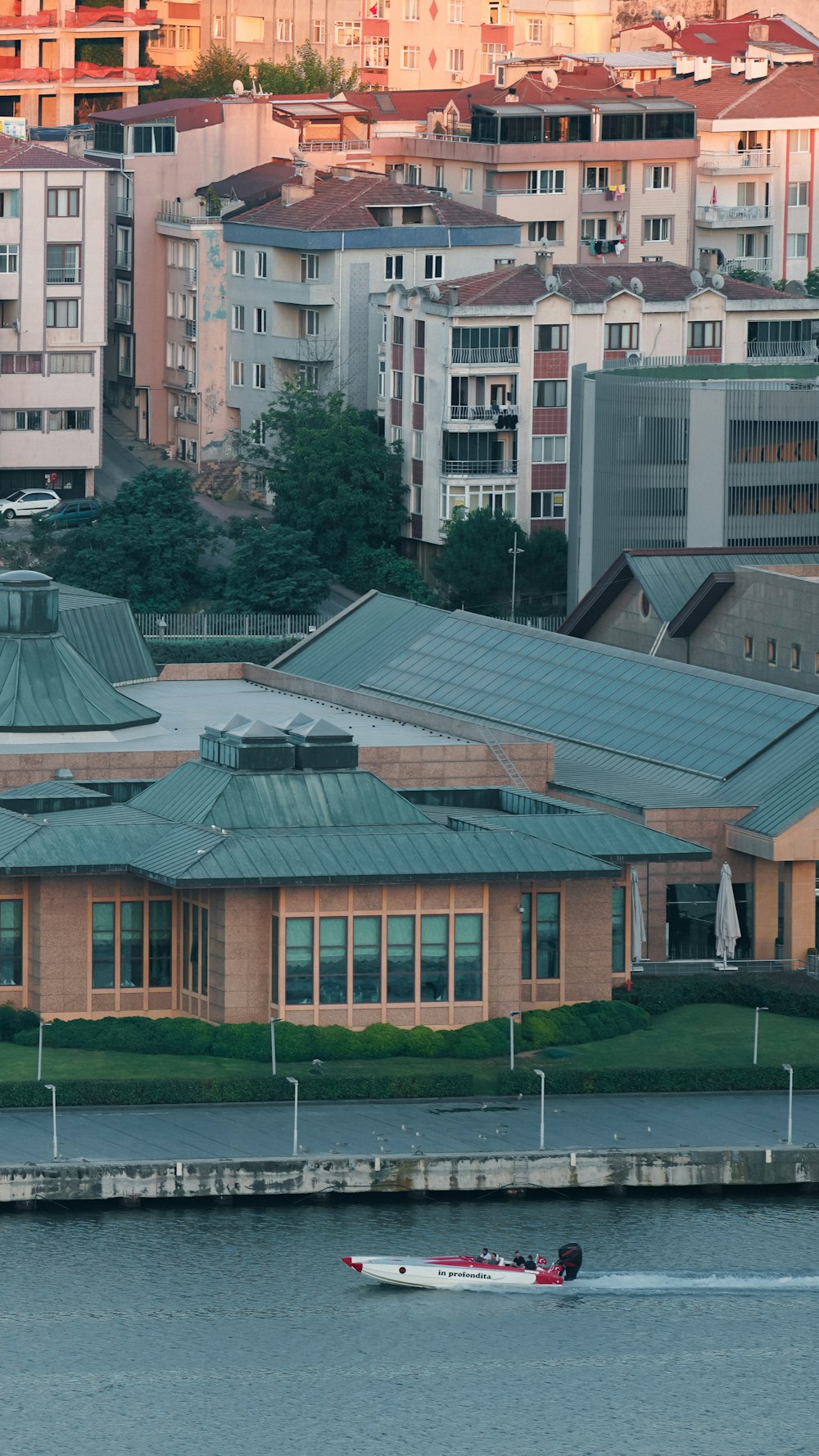 a boat is in the water in front of a building