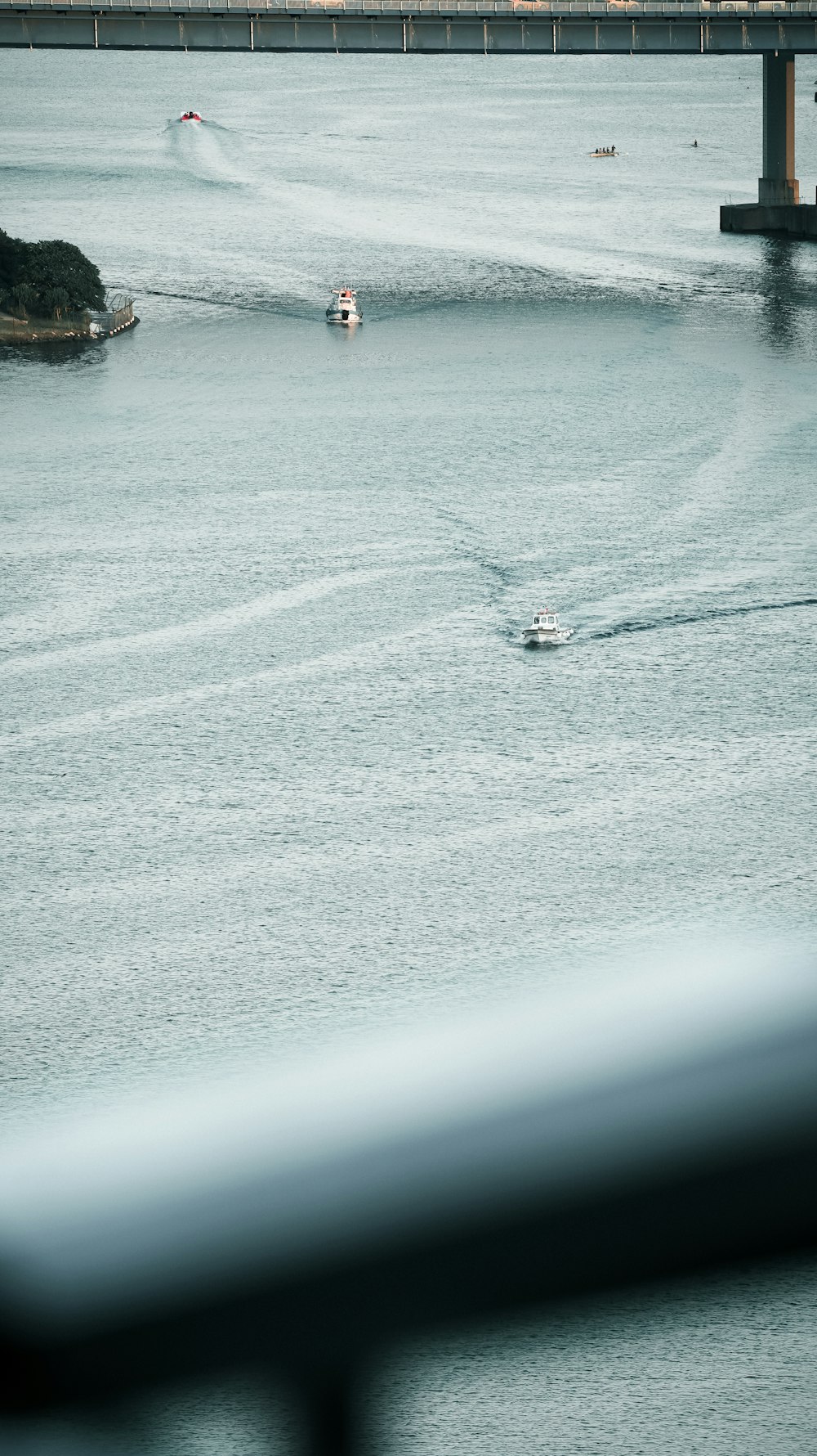 a couple of boats traveling across a large body of water