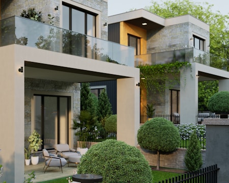 a house with a lot of trees and bushes in front of it