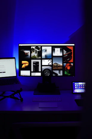 a desk with a laptop and a computer monitor
