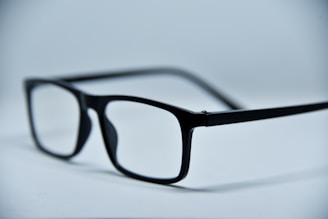 Two pairs of trendy eyeglass frames side by side on a clean white background.