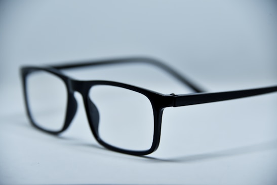 Two pairs of trendy eyeglass frames side by side on a clean white background.