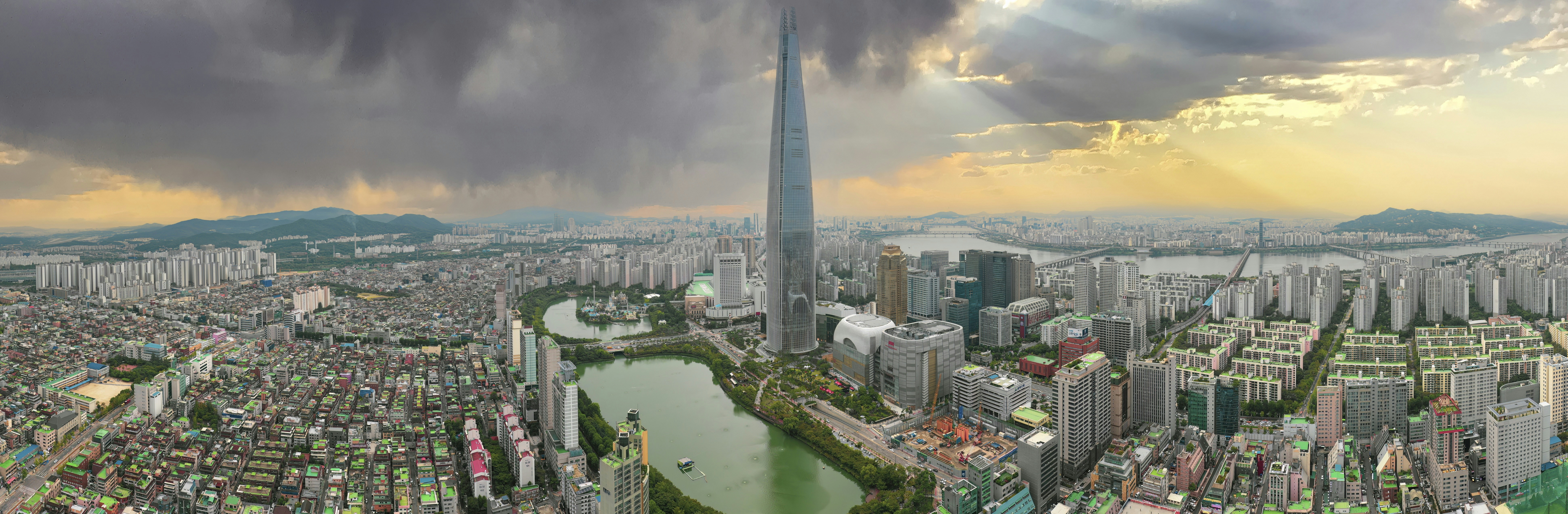 an aerial view of a city with a lake in the foreground