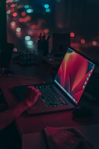 a laptop computer sitting on top of a wooden desk