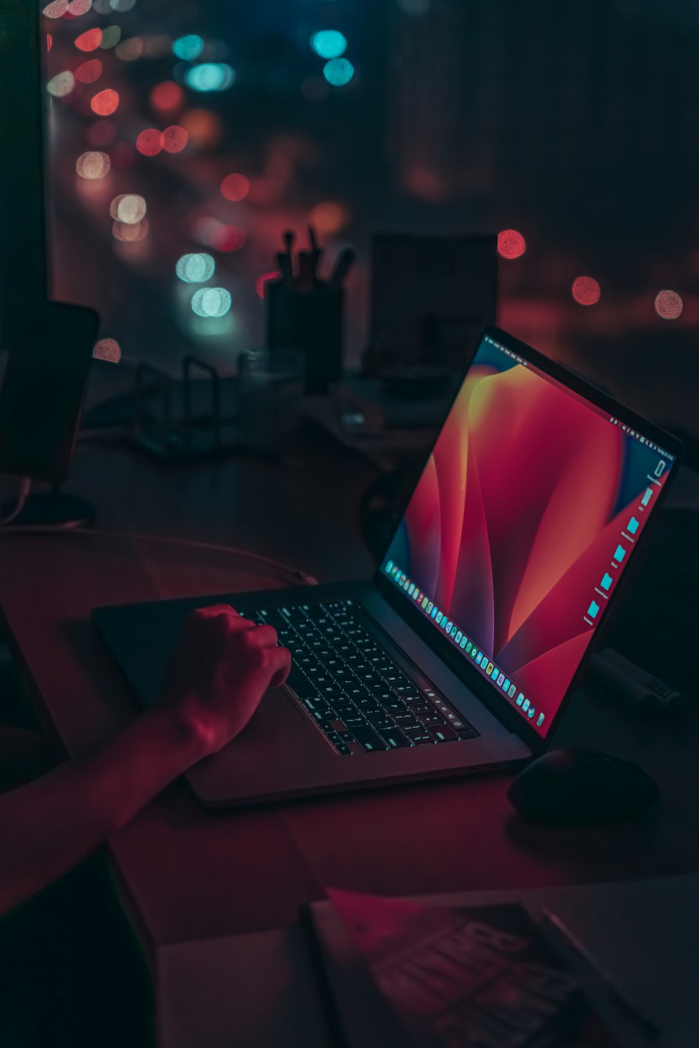 a laptop computer sitting on top of a wooden desk