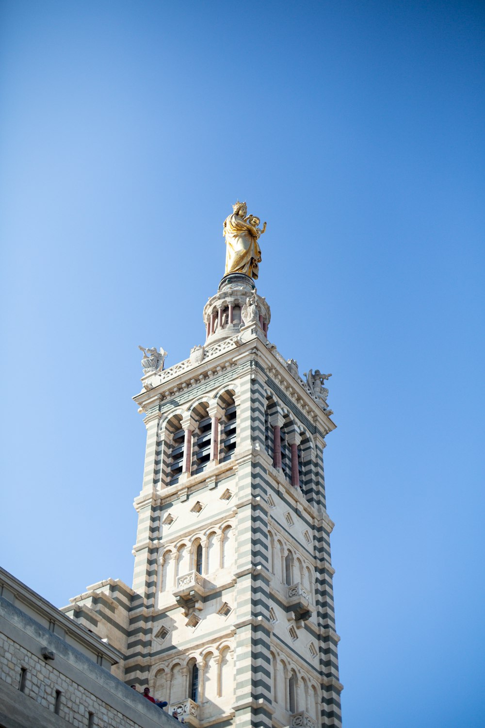 a clock tower with a statue on top of it