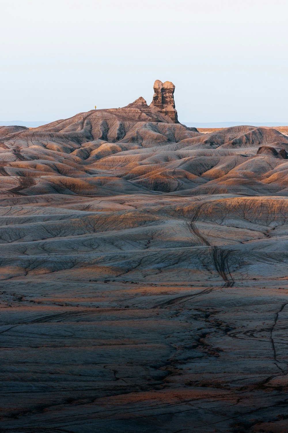 a large rock formation in the middle of a desert