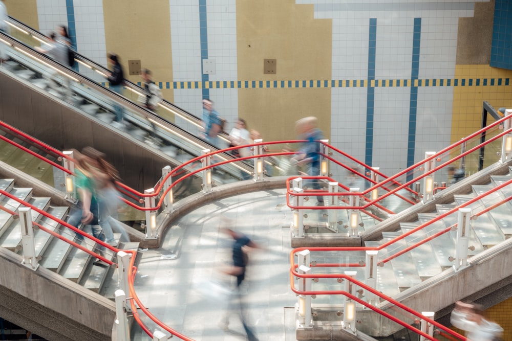 a group of people walking up and down an escalator