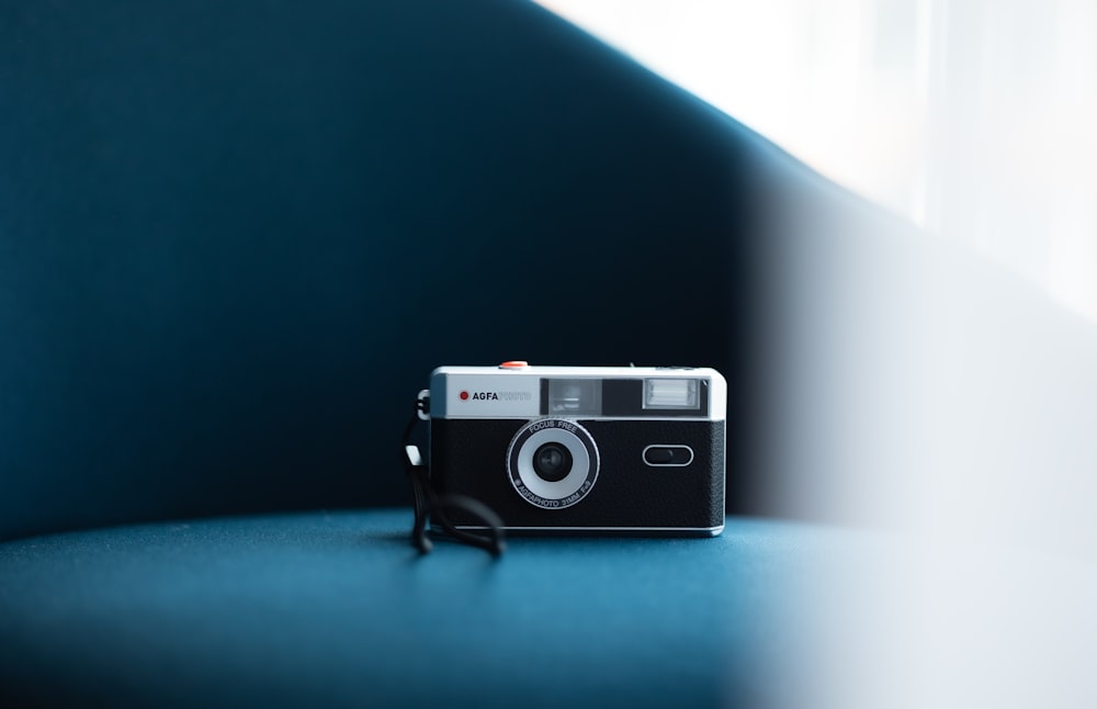 a camera sitting on top of a blue couch