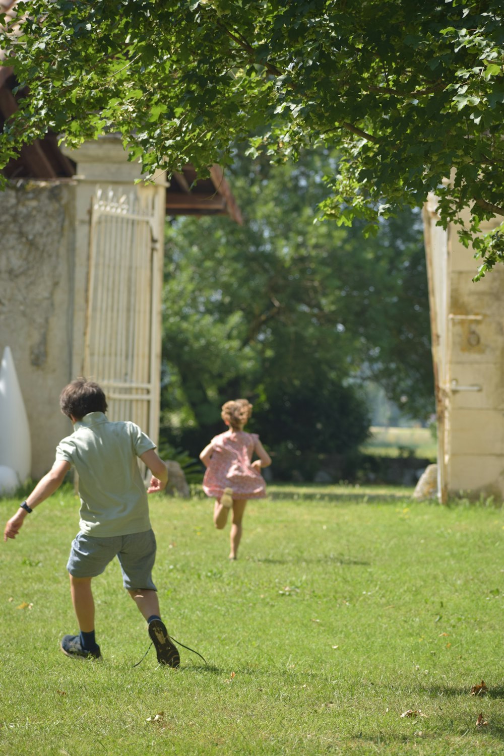 a couple of kids playing a game of frisbee