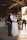 A candid shot of a bride and groom sharing their first dance with smiles and laughter, surrounded by friends.