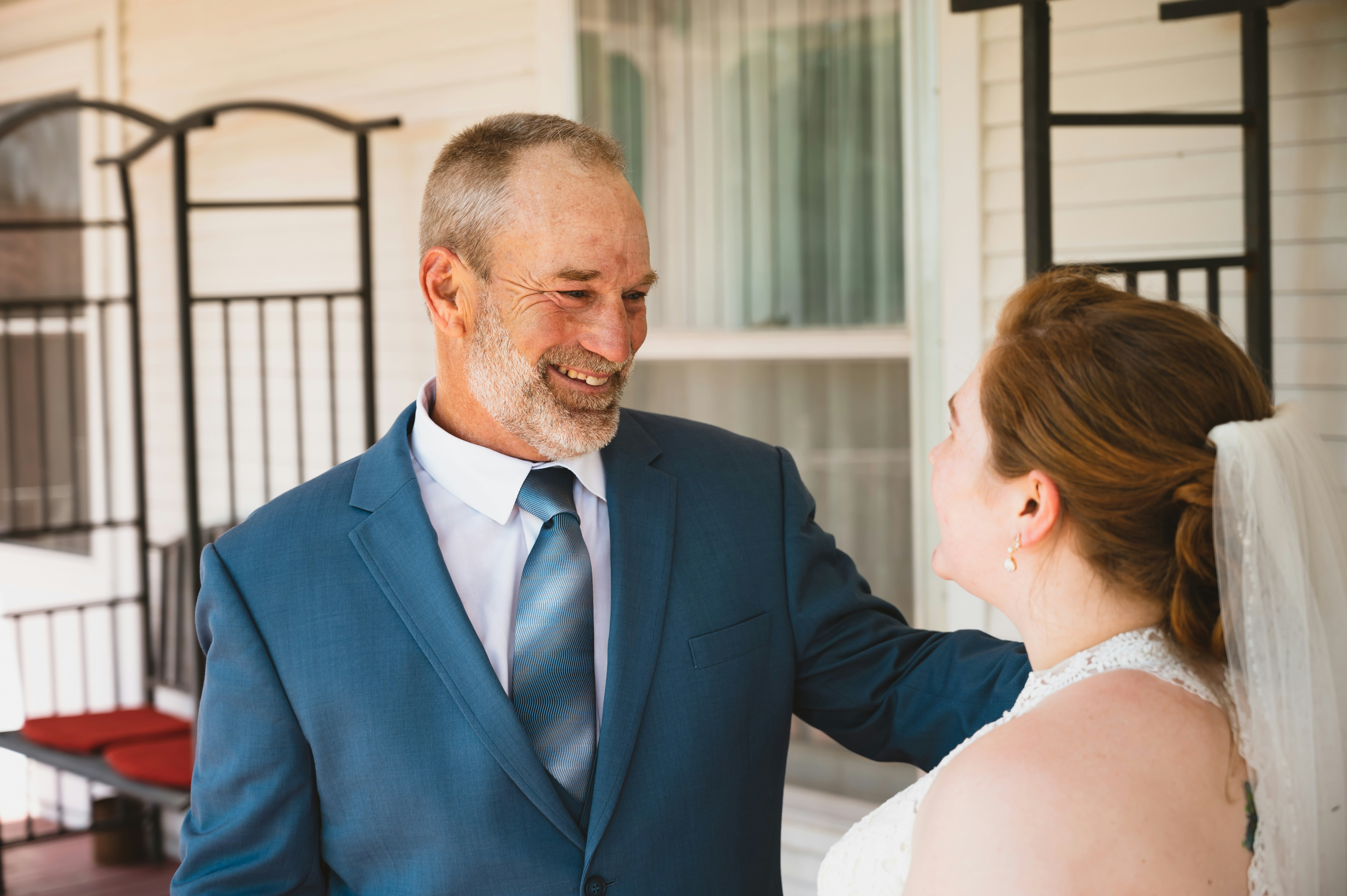 a man in a suit and tie standing next to a woman in a wedding dress