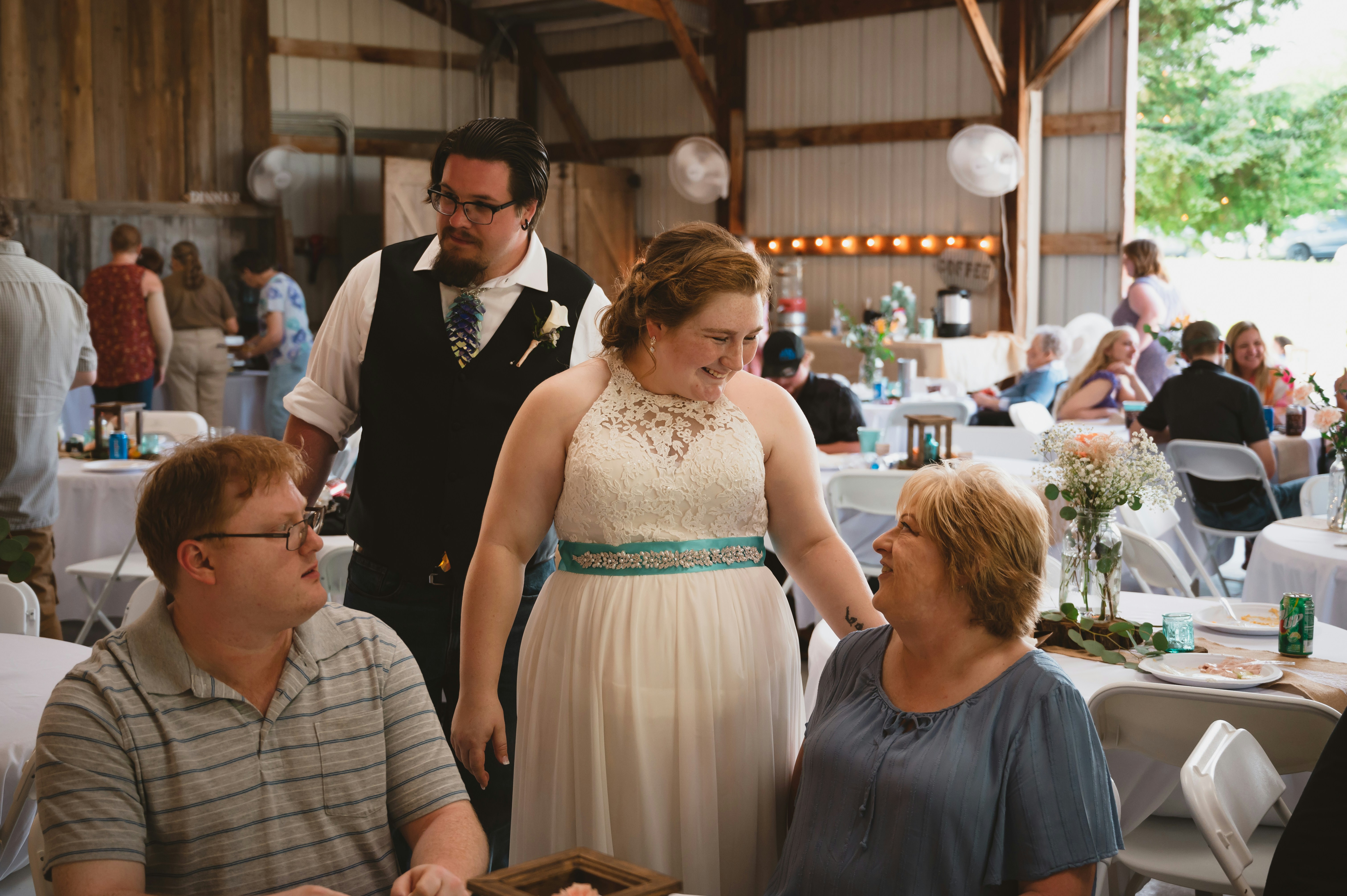 a woman in a white dress standing next to a man in a suit