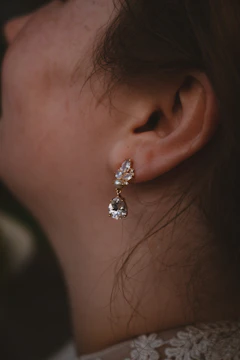 Rhodium-plated cubic zirconia earrings worn by a young Indian woman.