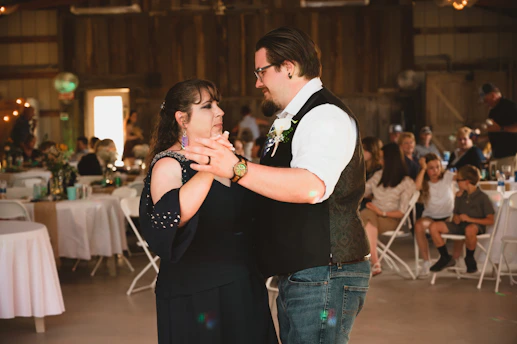 a man and a woman dance together at a wedding reception