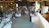 A warm, rustic wedding scene with a small live band playing outdoors surrounded by joyful guests.