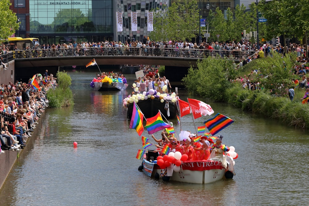 a group of people riding on top of a boat down a river