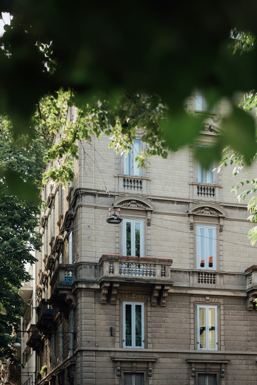 a tall building with balconies on the top of it