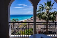 A beautiful view of a tropical beach from a hotel balcony.