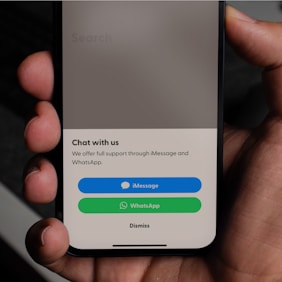 A smartphone displaying a WhatsApp chat with a friendly customer service representative.